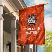 Orange Every Child Matters flag on pole, central emblem with dreamcatcher and feathers