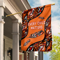 Orange flag on pole with black-red swirls and “EVERY CHILD MATTERS” text