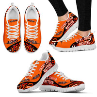 Orange sneakers, white sole, 'EVERY CHILD MATTERS' print with white laces