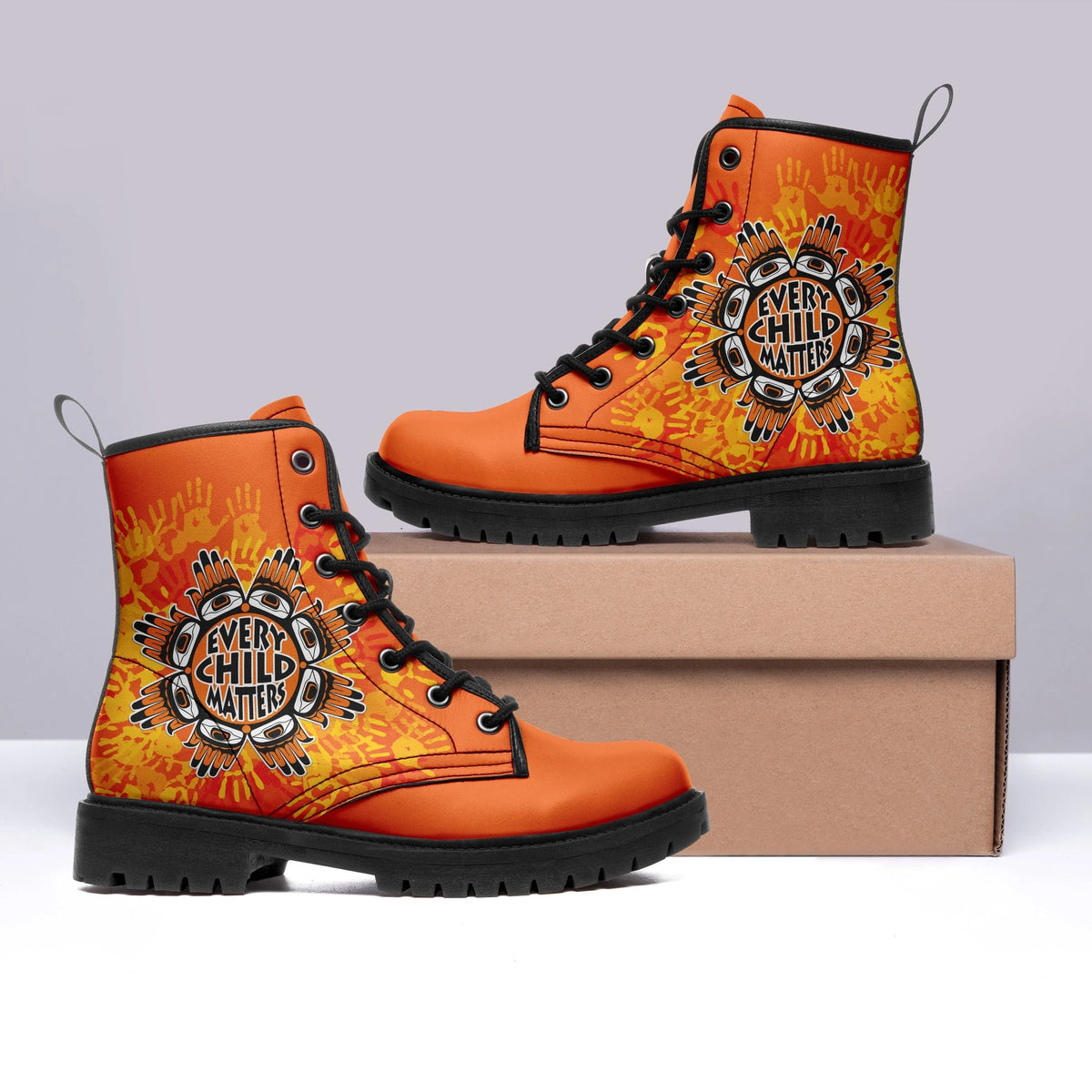 Orange boots, black laces, Every Child Matters graphic on sides, front angle.