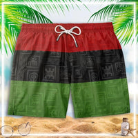 Color-block swim shorts with elastic waistband, drawstring, and red-black-green panel design