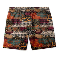 Men's tribal print shorts with drawstring waist and black/orange geometric motifs