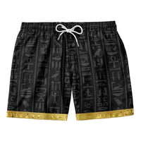 Men’s black drawstring shorts with Pharaoh-style symbols and gold/yellow bottom trim