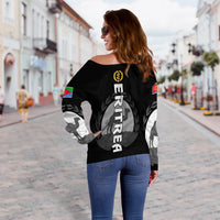 Black off-shoulder women’s sweater with vertical ERITREA text and crest on back