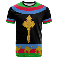 Black T-shirt with large gold cross emblem, Eritrea flag stripes, and camels