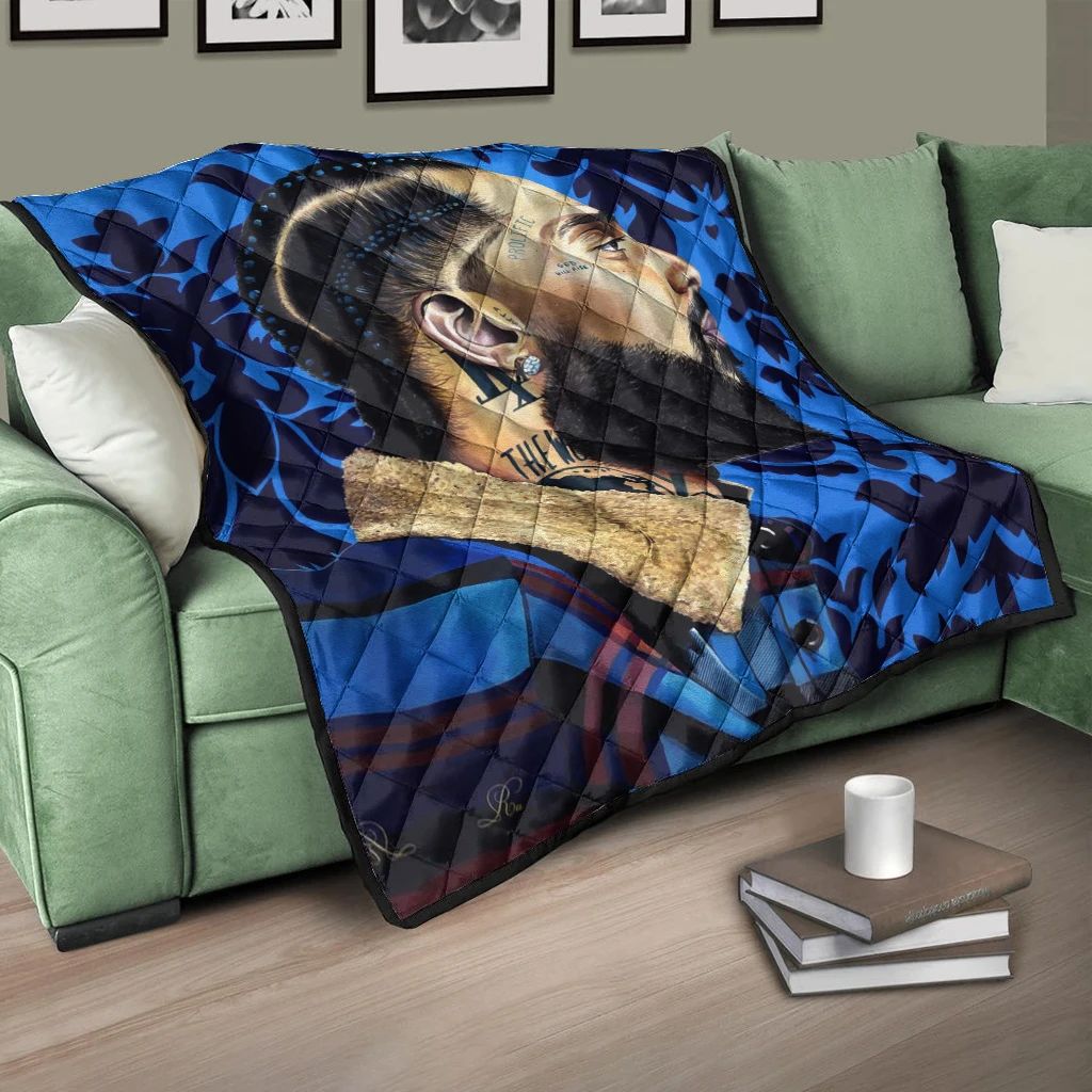 Blue quilt with bold portrait graphic and black quilted texture