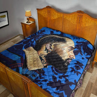 Blue quilt with side-profile portrait graphic and patchwork-style tan panel