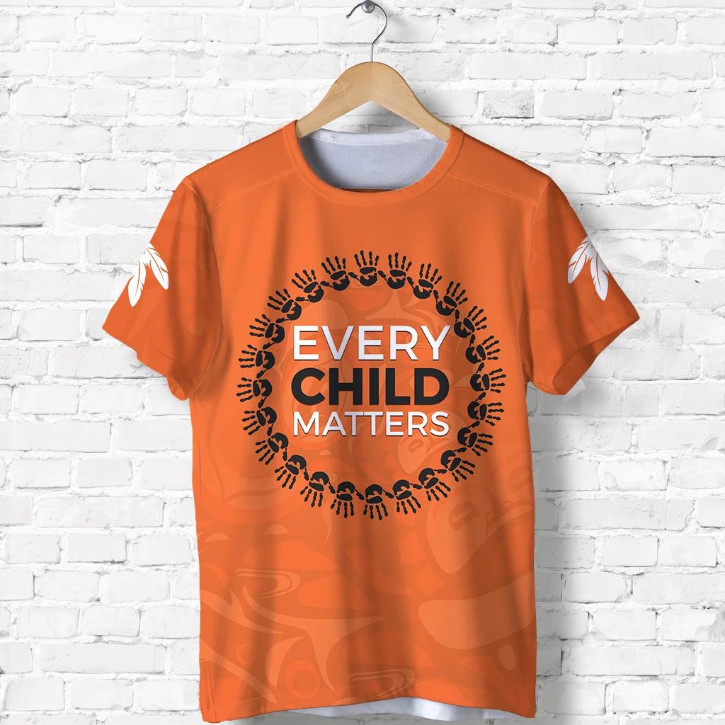Orange T-shirt with circular black handprint graphic and text "EVERY CHILD MATTERS"