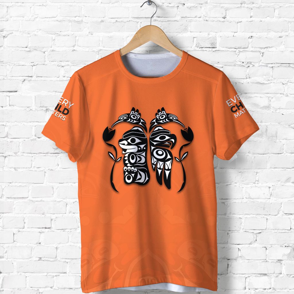 Orange T-shirt front with black-and-white totem bird graphic, partial sleeve text