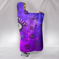 Purple hooded blanket with scattered evil-eye and gem graphics, hood edge visible