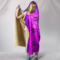 Purple hooded blanket with evil-eye motif, beige sherpa lining and hood opening