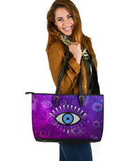 Purple evil eye tote bag in leather with black double handles and flat base