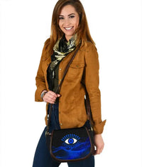 Blue evil eye saddle leather crossbody bag with black trim and adjustable strap