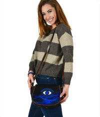 Blue evil eye leather saddle bag, rounded front with flap and crossbody strap