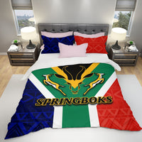 Springboks bedding set on bed with antelope logo comforter and matching blue, red, green pillows