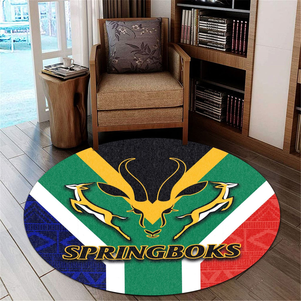 Round Springboks carpet with gold antelope logo and green, red, blue patterned bands