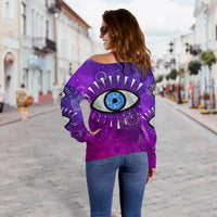 Purple off-shoulder sweatshirt with evil eye graphic, relaxed long-sleeve fit