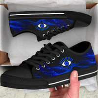 Pair of black low top sneakers with blue galaxy evil eye print and white stripe.