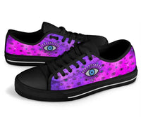 Pink low-top sneakers with evil eye print, black laces and dark rubber sole
