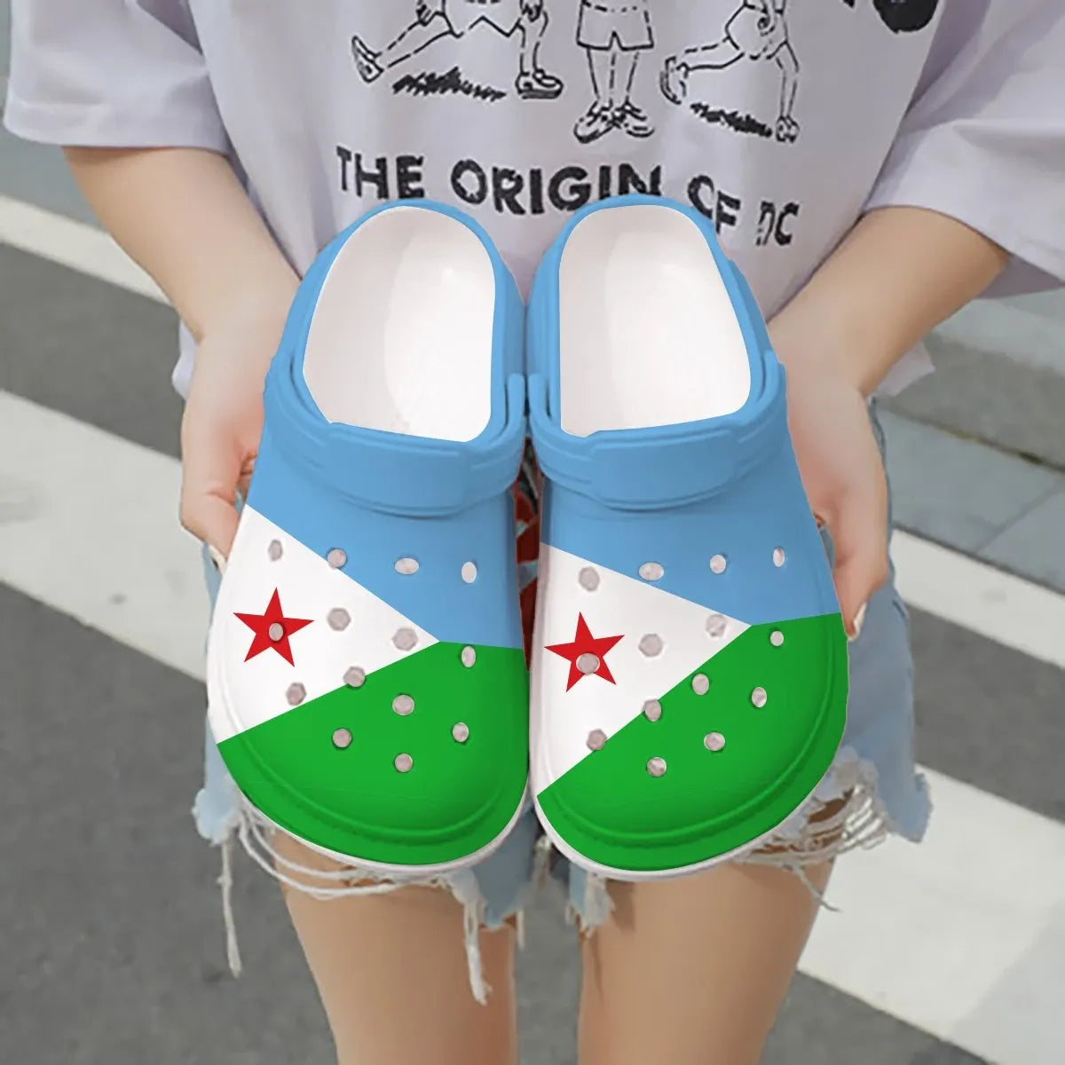 Djibouti flag clogs, blue-to-green with red star and white panels, pair held up
