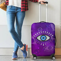Purple suitcase cover with large blue evil eye, starry rays and small eye motifs