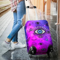 Purple-pink evil eye luggage cover over rolling suitcase, front design and wheels visible