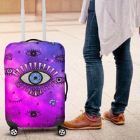 Pink evil eye luggage cover, side view of suitcase with caster wheels and lower corners