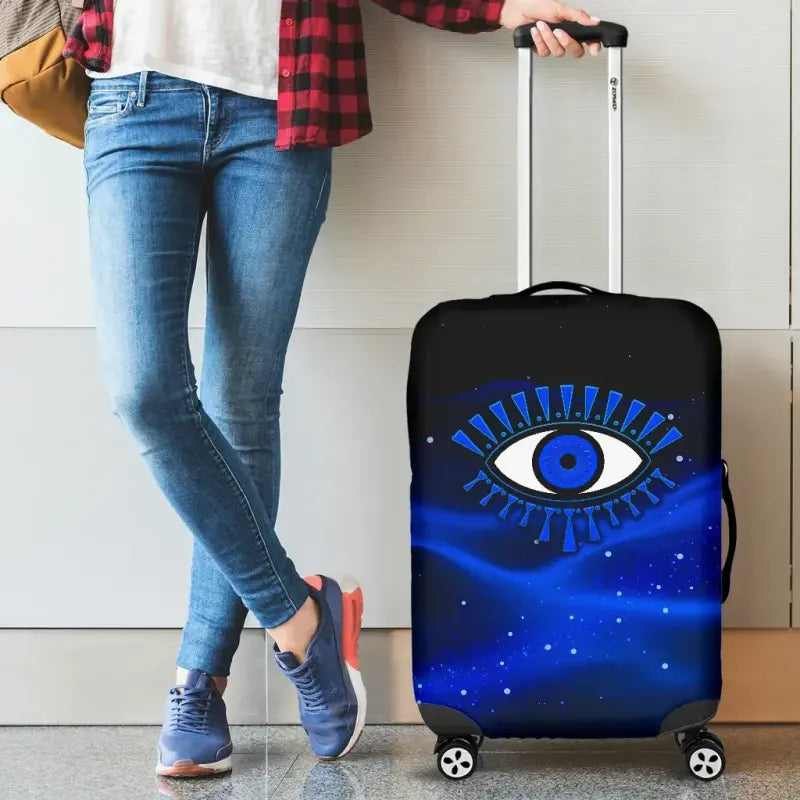Blue evil eye luggage cover fitted over a rolling suitcase with wheels