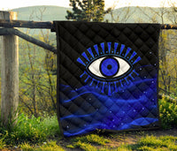 Outdoor view of blue-and-black evil eye premium quilt with diamond stitch pattern