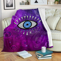 Purple evil eye universe blanket with large blue eye and star-like details.