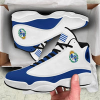 White and blue high-top sneaker with Uruguay crest on side, black laces, chunky sole.