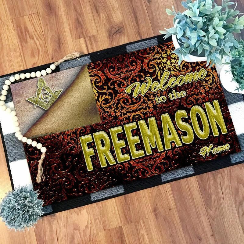 Red door mat with gold 'Welcome to the Freemason' text, ornate pattern, black edging