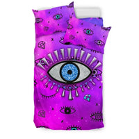 Pink bedding set showing duvet and pillowcases with evil eye symbols and purple accents