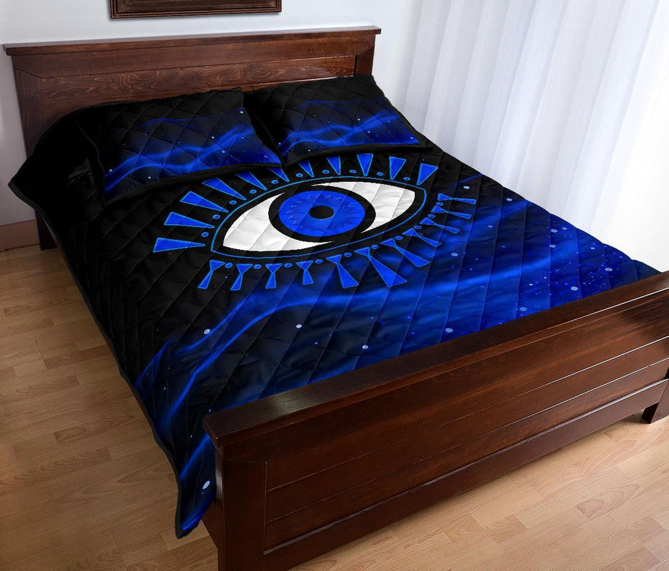 Blue and black evil eye quilt bed set corner view with central eye motif on quilt