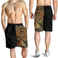 Model-worn black men's shorts with colorful Aztec sun stone side print, elastic waist