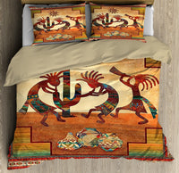 Printed bedding set showing central Kokopelli scene, desert hues, and matching pillow design