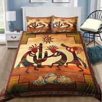 All-over printed duvet and pillowcases featuring Kokopelli figures, sun, and lizard art