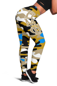 Camouflage leggings with large crest letters and blue accents; ankle to hip view