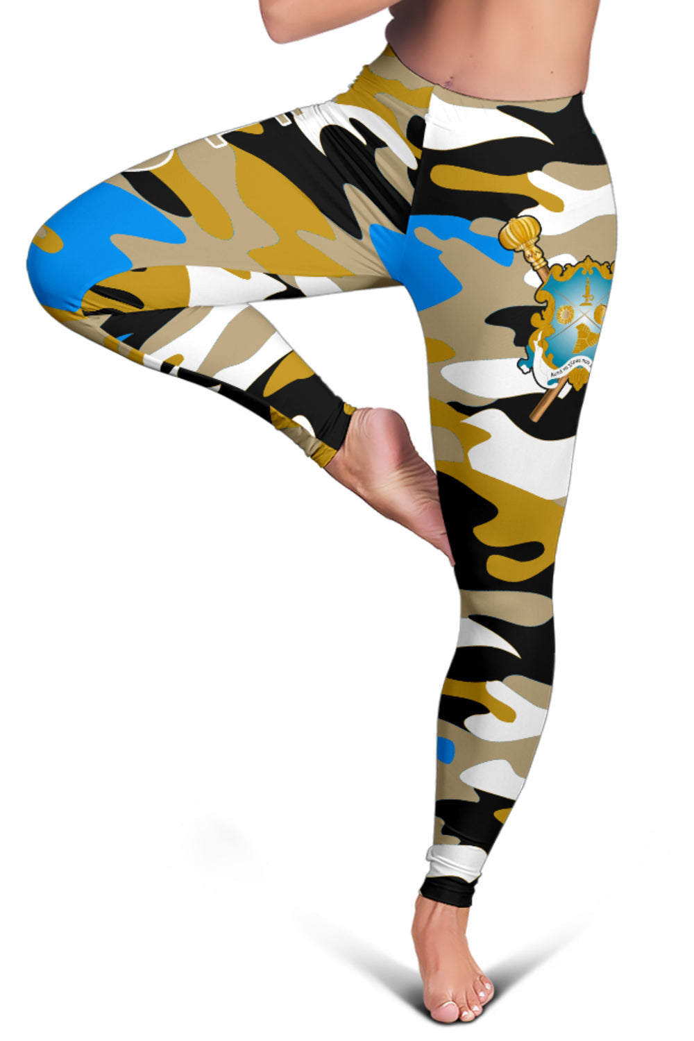 Camo leggings close-up: gold crest with sword; blue blotches on black and tan