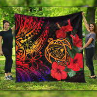 Quilt blanket with red hibiscus blooms and orange turtle graphic on black background