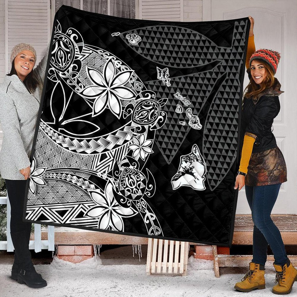 Black Hawaiian quilt with white floral tribal artwork and geometric tiki-style icons