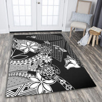 Black rug with white Polynesian motifs, zigzags, triangles, and stylized animal silhouettes