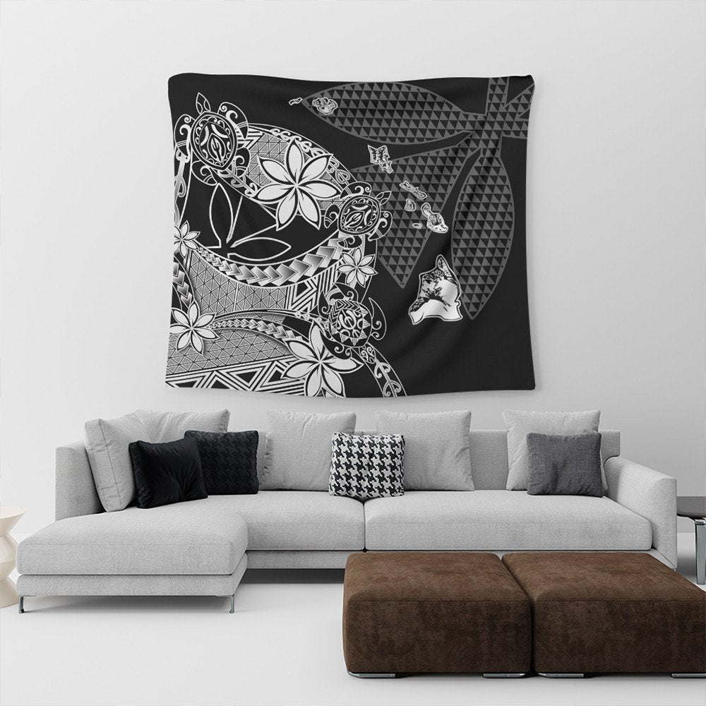 Black Hawaiian tapestry with white floral, geometric triangle patterns and stylized figures