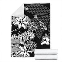 Black Hawaiian blanket set with white tribal floral and geometric motifs, folded towels