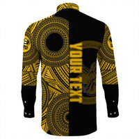Back view: black long-sleeve button shirt with vertical yellow/gold NANAKULI lettering