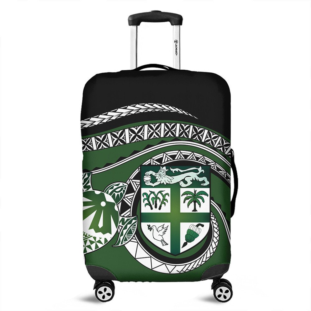 Green suitcase cover with Polynesian turtle crest and geometric patterns, wheel openings