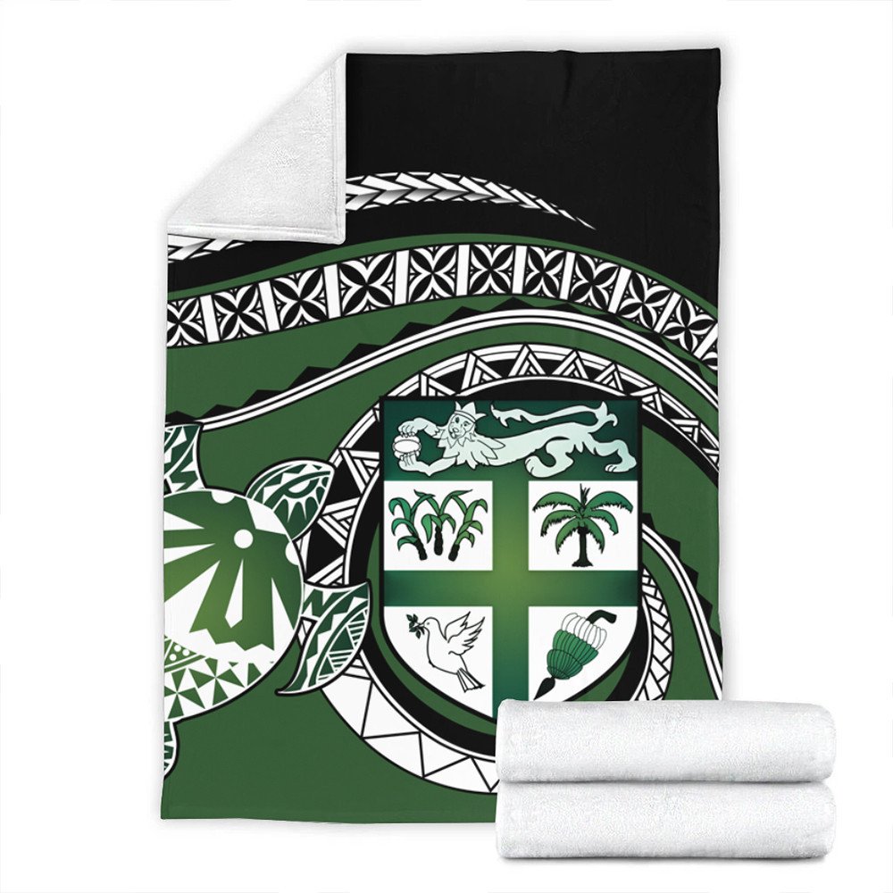 Green turtle-themed blanket with black top panel and tribal trim; includes two folded towels