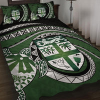 Green quilt bed set with turtle crest, quilted pattern and geometric borders