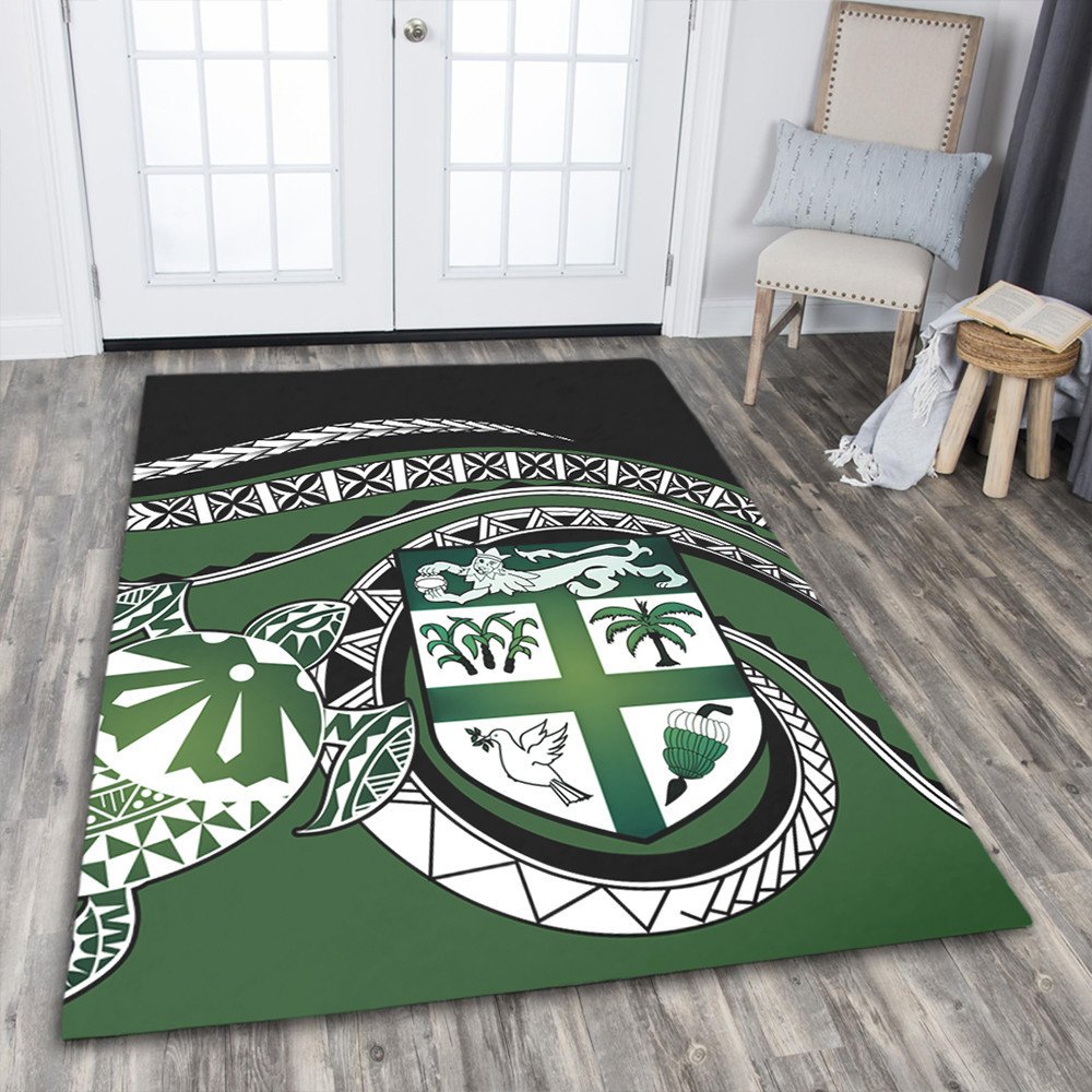 Green floor area rug with bold tribal geometric design and central turtle shield motif
