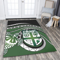 Green floor area rug with bold tribal geometric design and central turtle shield motif